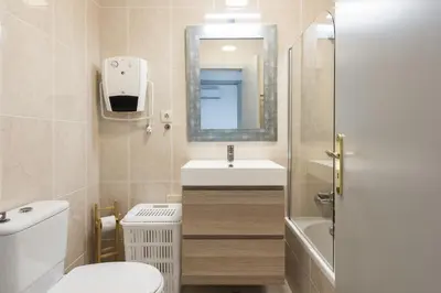 a bathroom with a sink and a toilet and a mirror at Terracos Falesia II - Terrace with pool by HD in Vilamoura