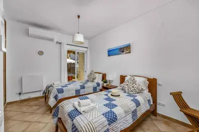 a bedroom with two beds and a table at Villa Algarhb by Villa Plus in Albufeira
