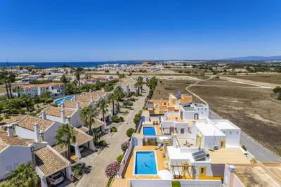 an aerial view of a villa with a resort at Villa Algarhb by Villa Plus in Albufeira