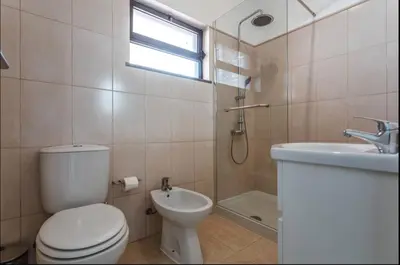 a bathroom with a toilet and a shower and a sink at Blife Aerya private rooms - Airport stay in Faro