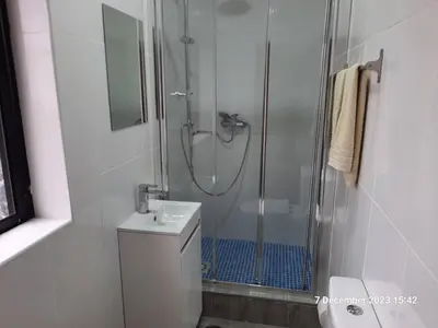 a bathroom with a shower and a toilet and a sink at Blife Aerya private rooms - Airport stay in Faro