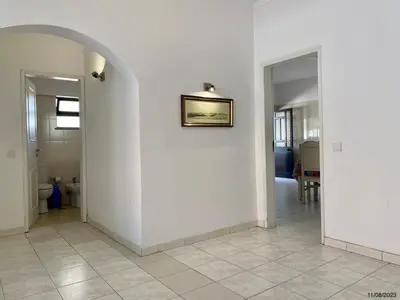 a hallway with white walls and a picture on a wall at Blife Aerya private rooms - Airport stay in Faro
