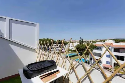 a typewriter sitting on a table on a balcony at Cozy studio near the beach in Quarteira