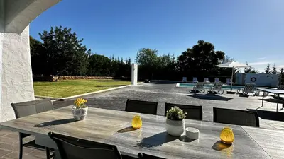 a wooden table and chairs on a patio at Mourisca by Check-in Portugal in Vilamoura