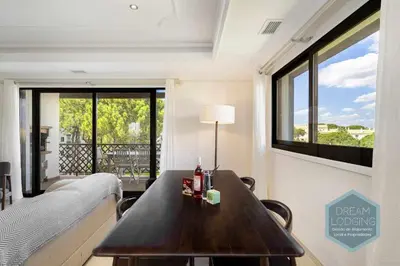 a room with a table and a bed and a window at Rooftop 27 - Dream Lodging in Albufeira