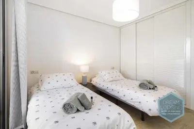 two twin beds in a room with a window at Rooftop 27 - Dream Lodging in Albufeira