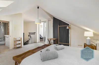 a bedroom with a large bed and a bathroom at Rooftop 27 - Dream Lodging in Albufeira