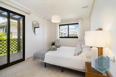 a white bedroom with a bed and a window at Rooftop 27 - Dream Lodging in Albufeira