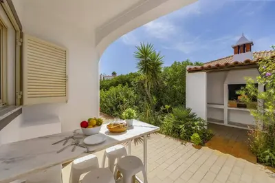 an outdoor patio with a table and chairs at Villa Casa Lourenco by Villa Plus in Albufeira