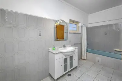 a white bathroom with a sink and a shower at Villa Casa Lourenco by Villa Plus in Albufeira