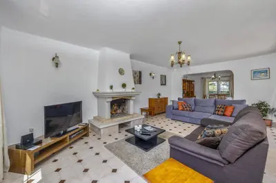 a living room with a blue couch and a fireplace at Villa Casa Lourenco by Villa Plus in Albufeira