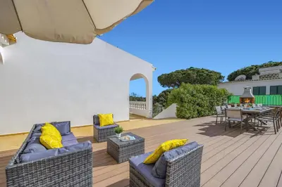 a patio with two couches and a table with a table at Villa Duas Sentinelas by Villa Plus in Cabeço de Câmara