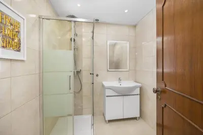 a bathroom with a glass shower and a sink at Villa Duas Sentinelas by Villa Plus in Cabeço de Câmara