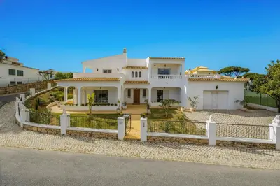 a large white house with a white fence at Villa Duas Sentinelas by Villa Plus in Cabeço de Câmara