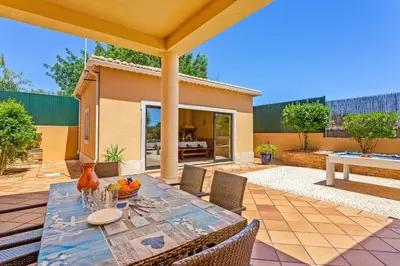 an outdoor patio with a table and chairs at Villa Karlia by Villa Plus in Galé