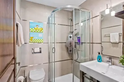 a bathroom with a shower and a toilet and a sink at Villa Karlia by Villa Plus in Galé