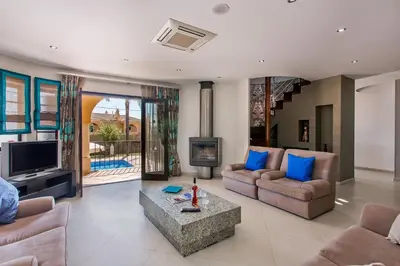 a living room with two couches and a tv at Villa Karlia by Villa Plus in Galé