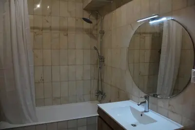 a bathroom with a tub and a sink and a mirror at Blife Chelsya private rooms in Faro
