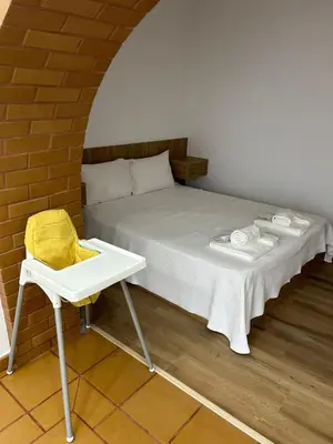 a bed with a table and a chair in a room at Casa Tapada do Bento I- Albufeira in Albufeira