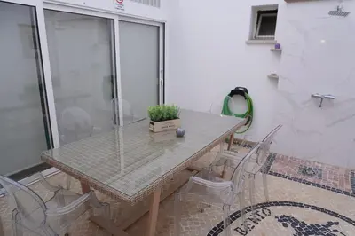 a table and chairs with a potted plant on it at Casa Tapada do Bento I- Albufeira in Albufeira