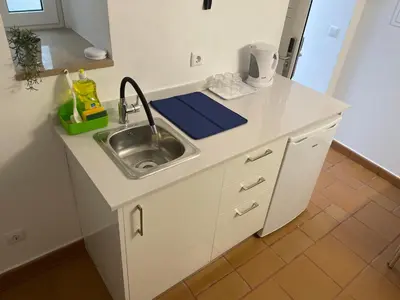 a kitchen with a sink and a counter top at Casa Tapada do Bento I- Albufeira in Albufeira