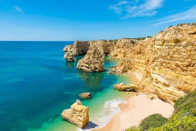 a view of a beach with rocks in the water at White Studio - Ocean View in Albufeira