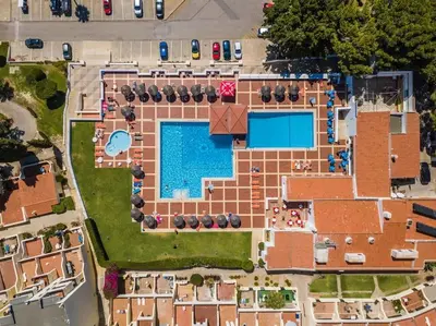 an overhead view of a building with a swimming pool at White Studio - Ocean View in Albufeira