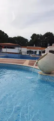 a swimming pool with a water fountain at White Studio - Ocean View in Albufeira