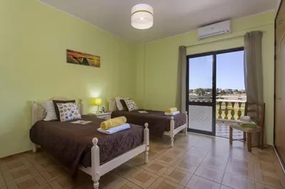 a bedroom with two beds and a balcony at Villa Luis Gale by Villa Plus in Galé