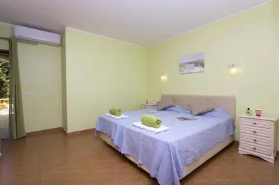 a bedroom with a bed with two towels on it at Villa Lurdes by Villa Plus in Galé