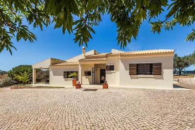 a white house with a brick driveway at Loendros, Calma Moradia com Piscina Privada, Guia in Guia