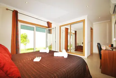 a bedroom with a bed with a large window at Villa Anna by Algarve Vacation in Albufeira