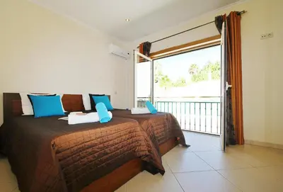 a bedroom with a bed and a large window at Villa Anna by Algarve Vacation in Albufeira
