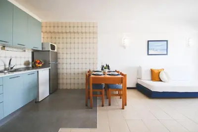 a small kitchen with a table and a bed in a room at Apartment Atlantic Sea by Algarve Vacation in Albufeira