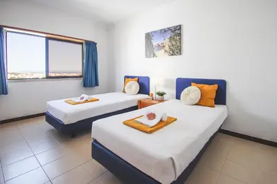 a room with two beds and a window at Apartment Atlantic Sea by Algarve Vacation in Albufeira