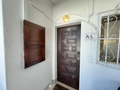 a wooden door in a room with a door sidx sidx sidx at Albufeira Central 7 by Homing in Albufeira