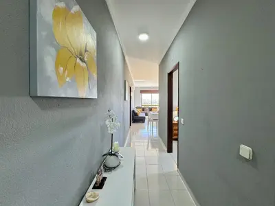 a small kitchen with a microwave and a sink at Albufeira Central 8 by Homing in Albufeira