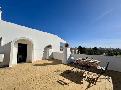 a bedroom with a bed with two towels on it at Albufeira Central 8 by Homing in Albufeira