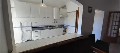 a small kitchen with white cabinets and a sink at Apartamento T1 todo equipado in Albufeira