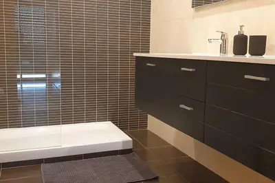 a bathroom with a sink and a toilet and a tub at Casa Praia Patroves in Patroves