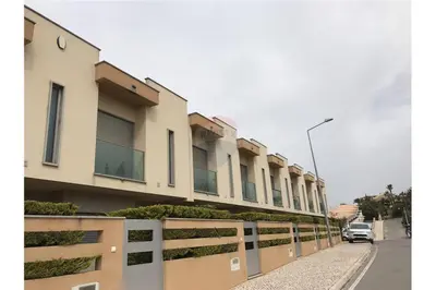 a row of buildings on a street with a car at Casa Praia Patroves in Patroves