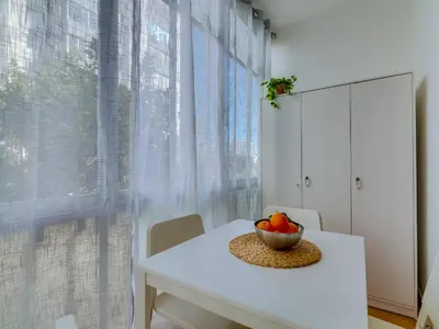 a white dining room table with a bowl of fruit at AL - Beachside Hideaway Quarteira in Quarteira