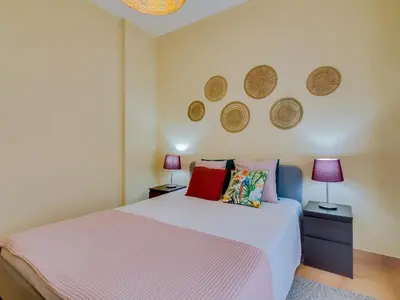 a bedroom with a white bed and two lamps at AL - Beachside Hideaway Quarteira in Quarteira