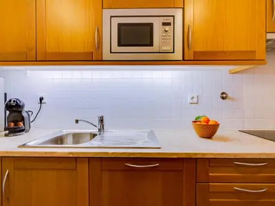 a kitchen with a sink and a microwave at AL - Vila Sol Golfside Ground Floor in Vilamoura