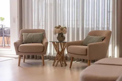 two chairs and a table in a room with a window at Phenthouse Monaco - Jacuzzi - City Center - Sea View in Albufeira