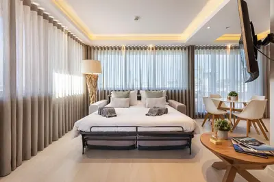 a bedroom with a large bed and a table at Phenthouse Monaco - Jacuzzi - City Center - Sea View in Albufeira