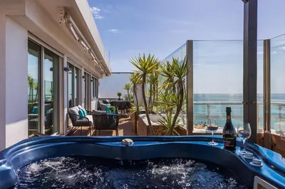 a hot tub in a building with a view of the ocean at Phenthouse Monaco - Jacuzzi - City Center - Sea View in Albufeira