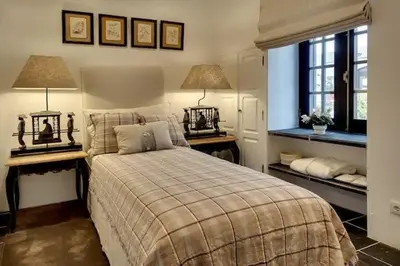a bedroom with a bed with two tables and two lamps at Casa Chanel - Ocean front with rooftop SPA Jacuzzi in Albufeira