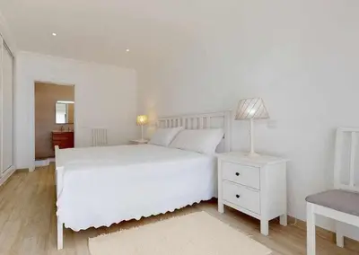 a white bedroom with a white bed and a lamp at Villa Malmequer by FHR private in Quarteira