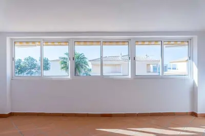 an empty room with windows and a white wall at Villa Sofy in Galé